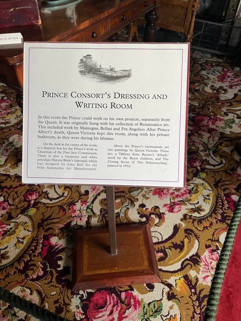 A tilted informational sign in a room.