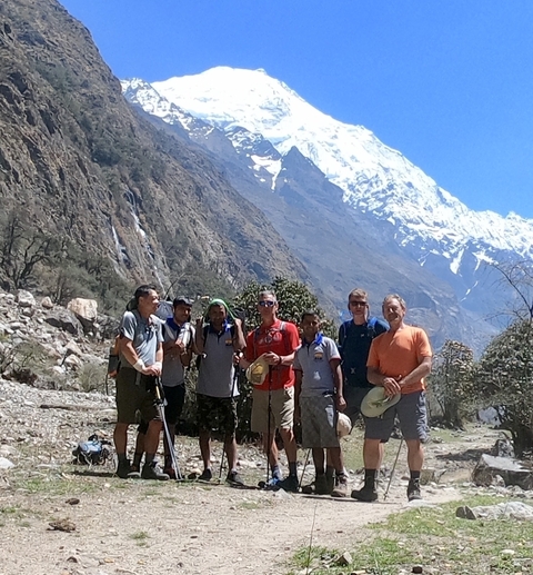       Group of hikers posing with mountain in the background.
  