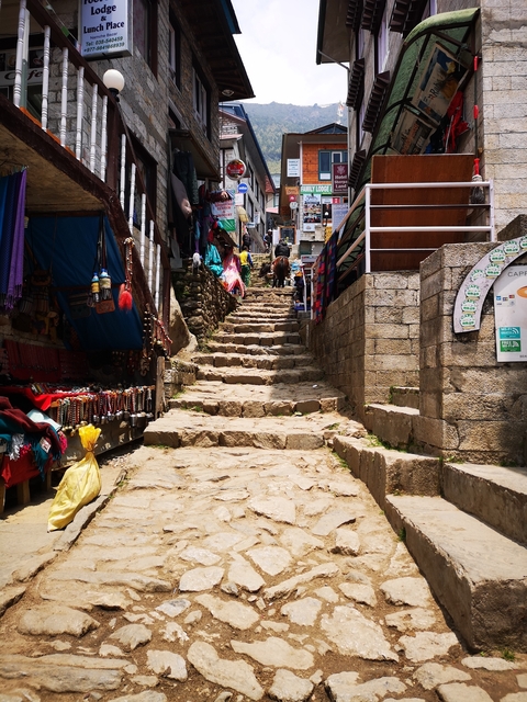       Stone steps lined with colorful market stalls.
  