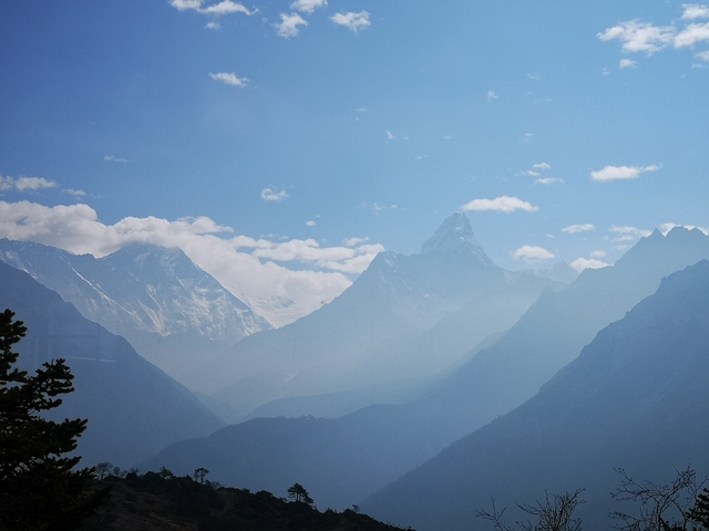       Panoramic view of majestic mountains under a clear blue sky.
  