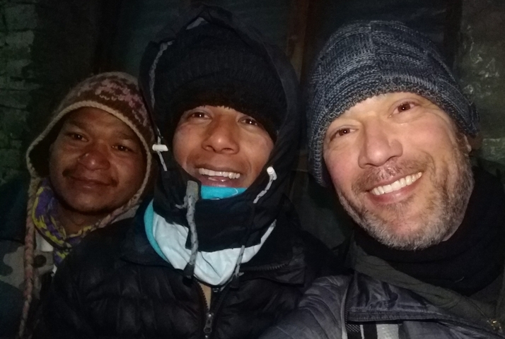       Group of people in winter clothing indoors.
  