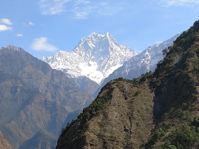       Snowy mountain peaks against a clear sky.
  