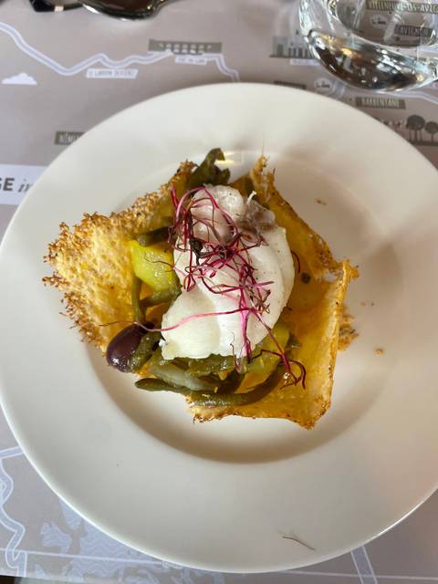       Gourmet dish with fish and vegetables on a plate.
  