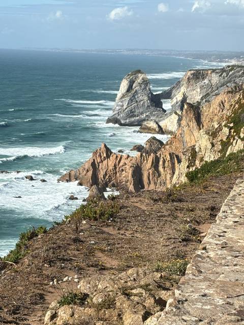 Rocky coastline with waves hitting rocks.
