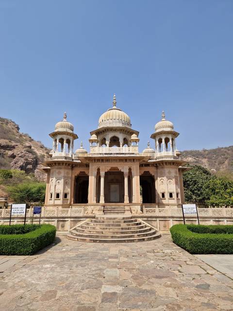       Historical temple with multiple domes under a clear sky.
  