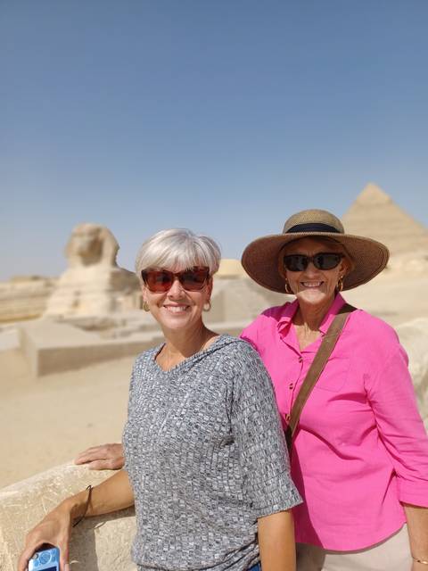 Two people at a sightseeing location, possibly near the pyramids.