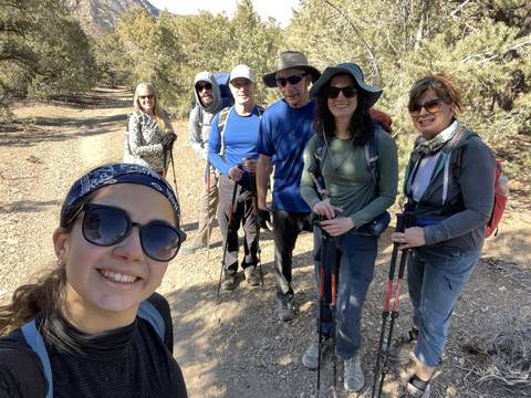      Group of people hiking on a sunny day.
  