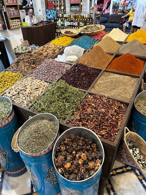       Colorful display of spices in a market setting.
  