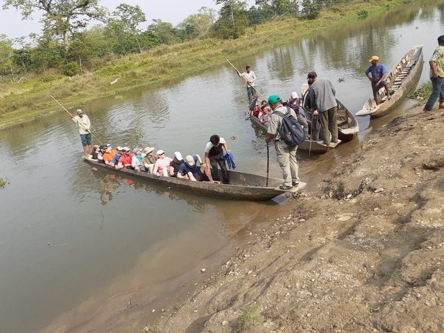 Group of people in a canoe on a river.