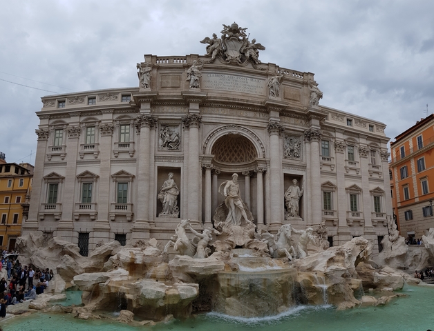 Trevi Fountain in Rome with intricate sculptures and water.