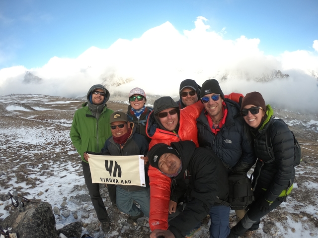       A group of trekkers posing in snowy mountains.
  