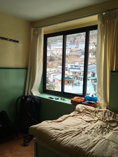       Window view from an indoor setting overlooking a village.
  