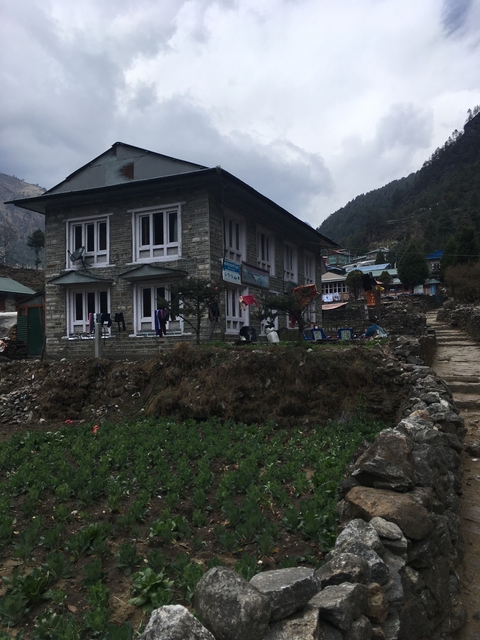       A stone building in a mountainous village setting.
  