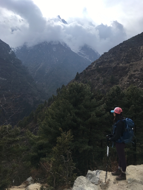       A person admiring the view from a mountainous terrain.
  