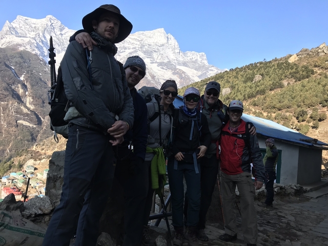       Group of hikers posing with a mountain in the background.
  