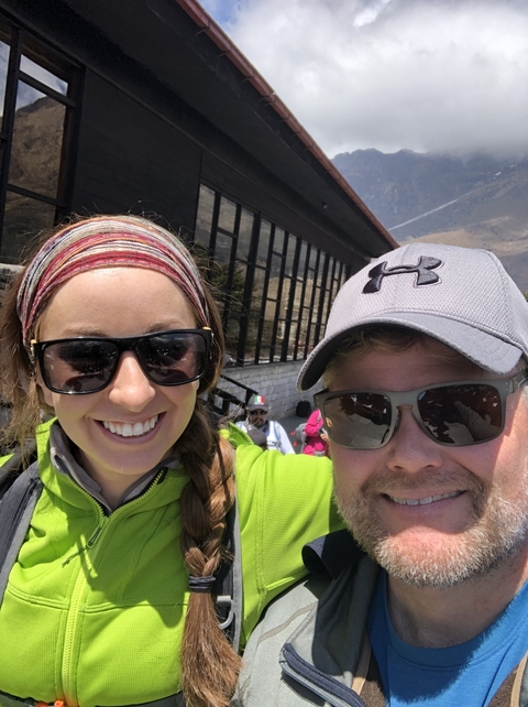       Close-up of a smiling couple in hiking attire.
  