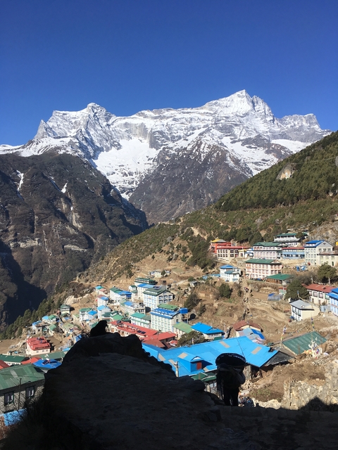       A scenic view of a village nestled in the mountains.
  