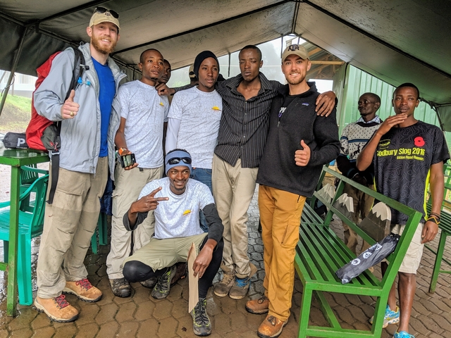       Group of climbers resting in a tented area.
  