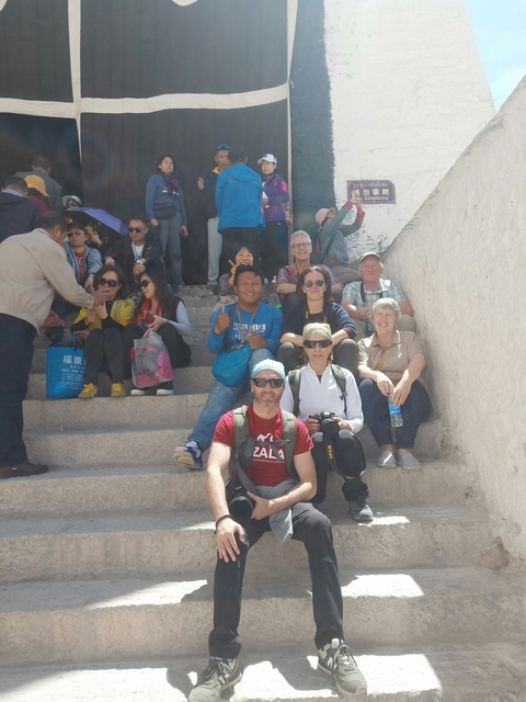 Group of people sitting on stairs outdoors.