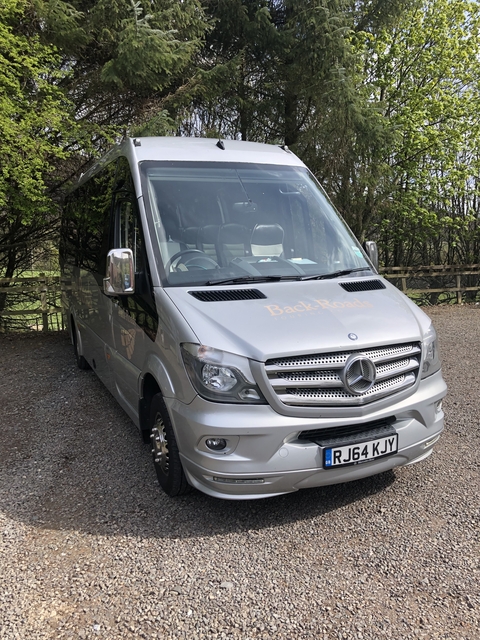 Tour bus parked on a road.