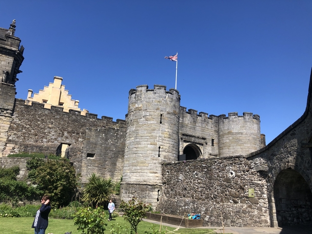 Historic castle with stone walls and flag.
