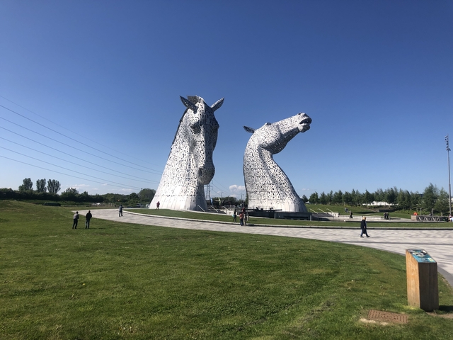 Large equine sculptures in a park setting.