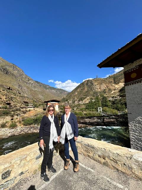       Two people standing on a mountain road
  