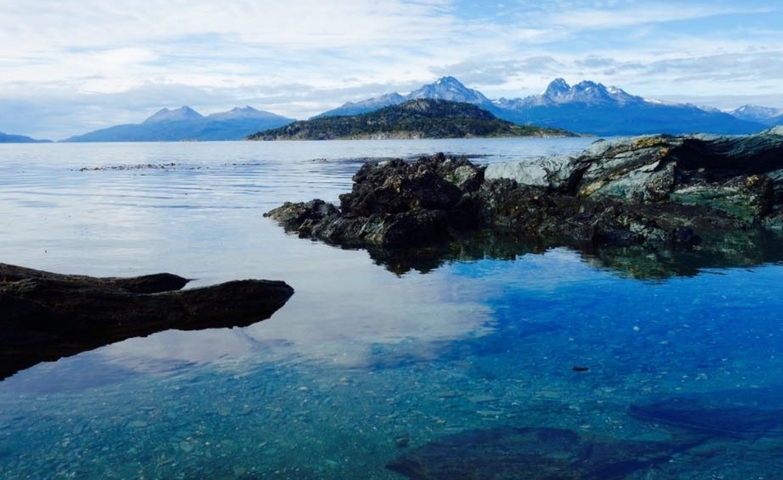 A tranquil lake with mountains in the background.