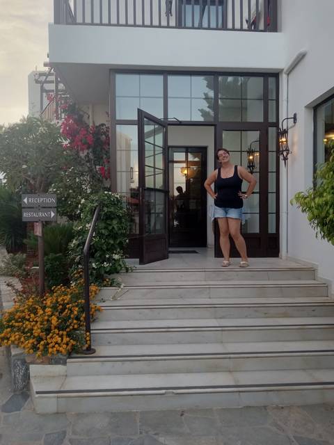       Woman standing on steps outside a building.
  