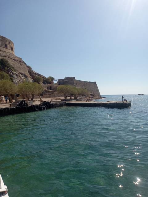       Coastal scene with turquoise water and rocky landscape.
  