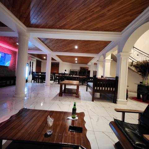       Inside view of a restaurant with wooden decor.
  