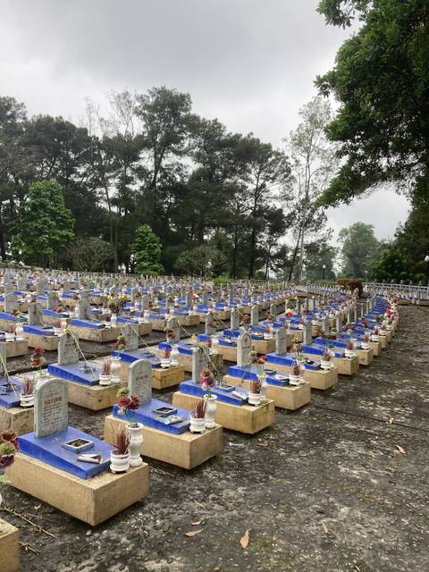 Large cemetery with rows of ornate gravestones