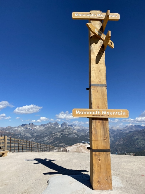       Scenic view of mountains with sign stating Mammoth Mountain elevation.
  