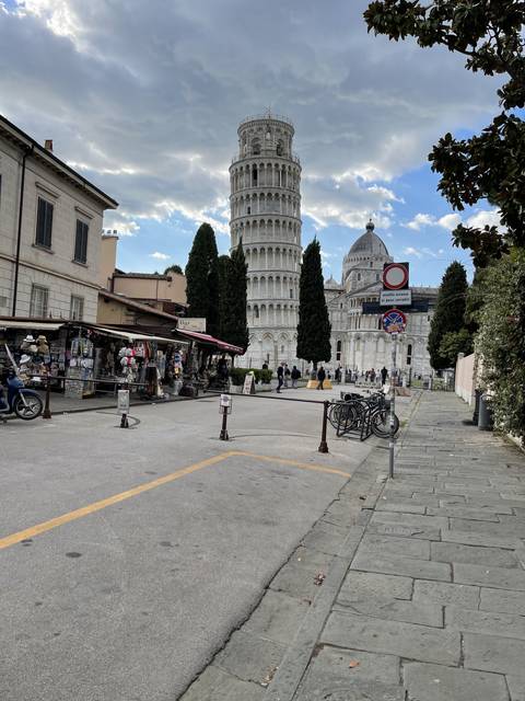 The Leaning Tower of Pisa with tourists nearby.