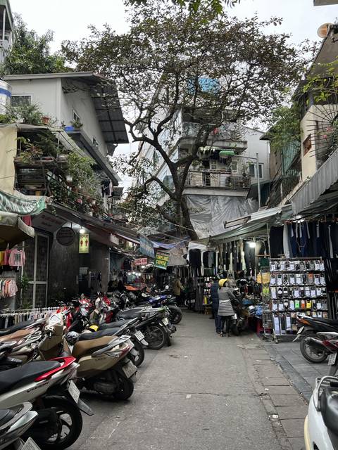       Street scene with shops and many motorcycles.
  