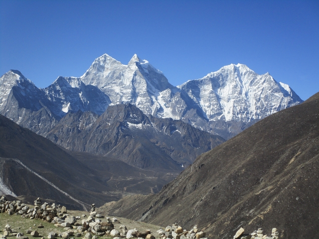 Majestic snow-covered peaks against a clear blue sky.