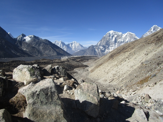Snow-capped mountains with a rocky foreground.