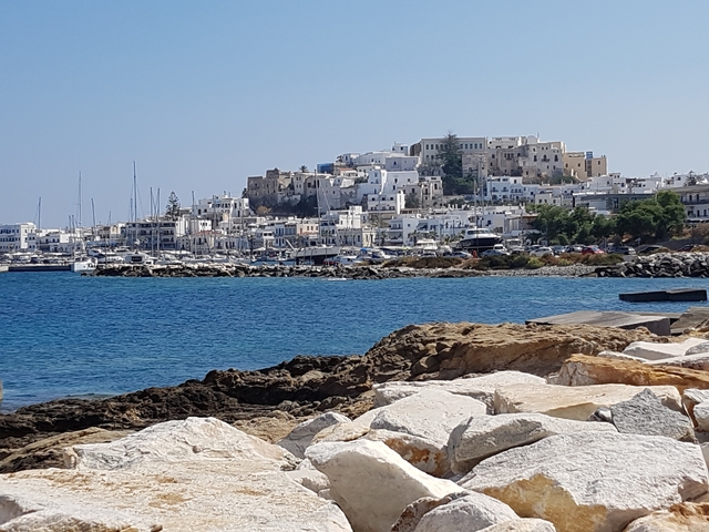 Coastal town with white buildings and a harbor.