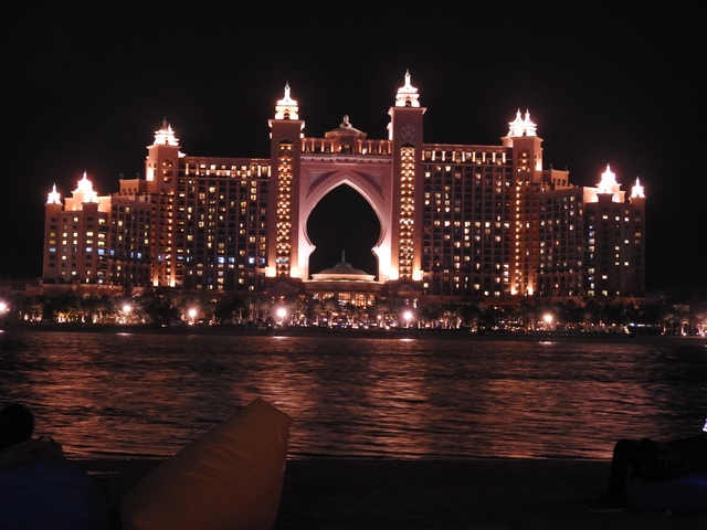 Night view of the Atlantis Hotel lit up against a dark sky.