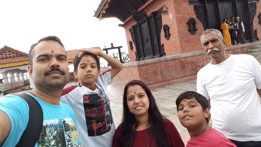 Family selfie in front of a traditional building.