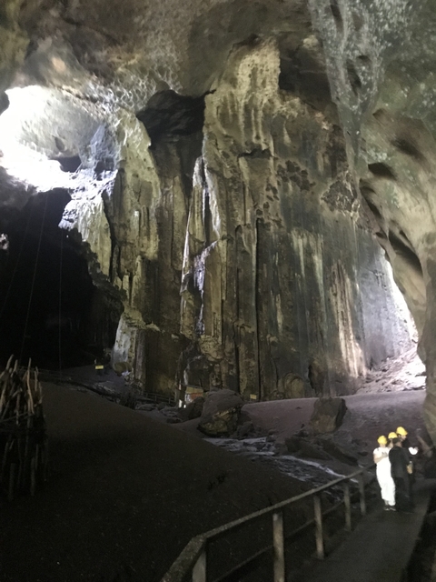       Dark cave interior with stalactites.
  
