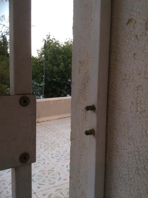 View from a partially obstructed window with blurred details.