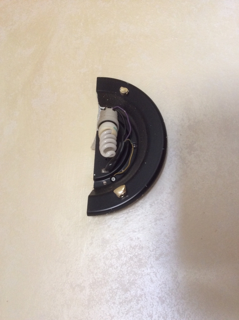       Broken wall-mounted light fixture with exposed wires.
  