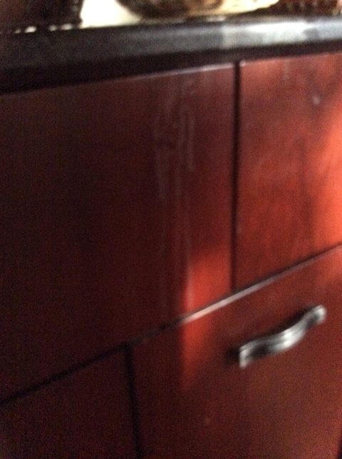 Wooden surface with faint details and poor contrast.