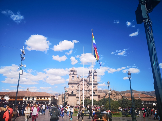 View of a grand cathedral with twin towers under a clear blue sky.