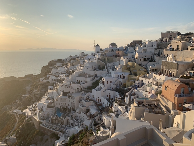       Sunset view over the iconic architecture of Santorini.
  