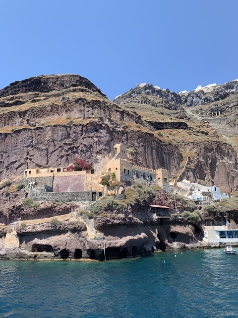 Historic structures built into a rugged cliffside.