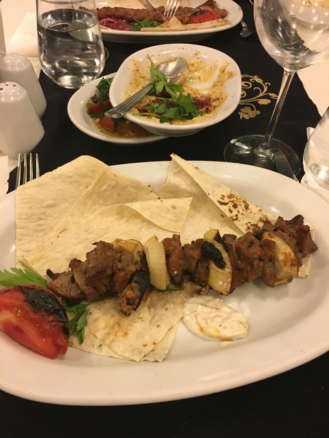 Dish featuring skewered meat and bread.