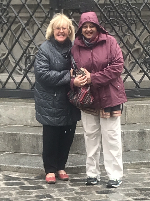 Two women posing with their arms around each other.
