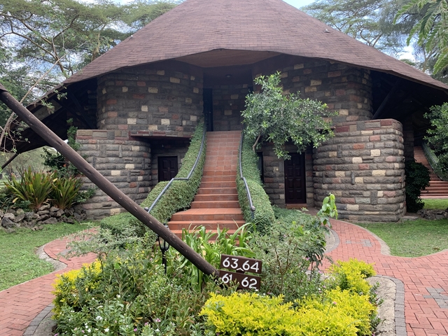 A building with a staircase and lush greenery.